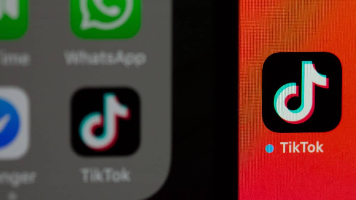 icona app TikTok su sfondo rosso bloccare TikTok e social pericolo